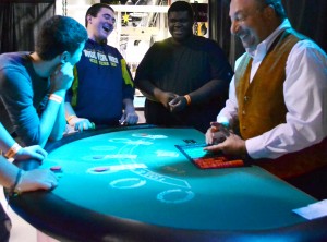 PVCC President Frank Friedman tries his hand at  dealing blackjack.  Photograph by Jessica Hackley.