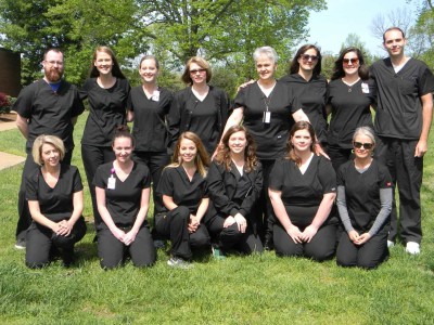 students pose for group picture in scrubs