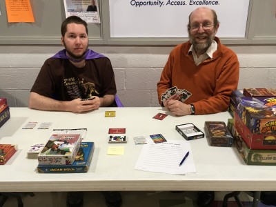 Professor Glassco and student play a card game at club day 