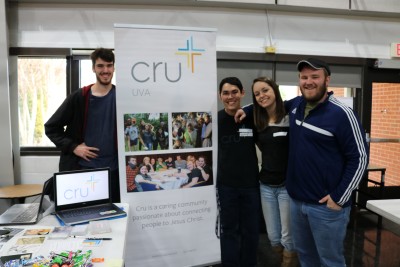 Cru student pose with Cru poster at club day