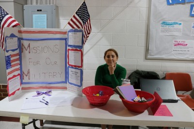 Erin Sonnenburg poses at club day table