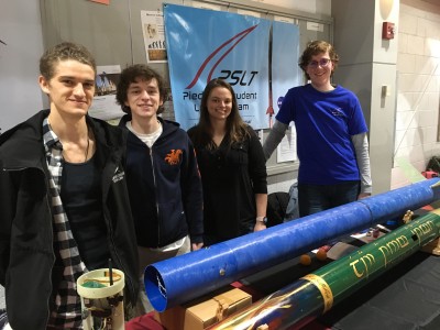 students pose with rockets