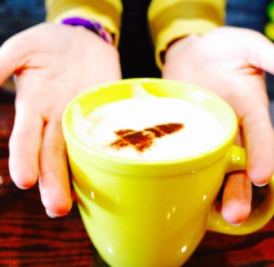 Paige Naylor posing with her pistachio latte.  Photography by Madison Weikle. 