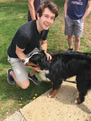 PVCC student Kyle Maciolek petting therapy dog Marlee outside PVCC. Photo by Madison Weikle