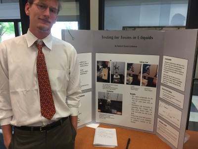 Robert Coleman poses with his poster