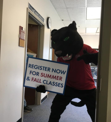 PVCC's panther mascot Pouncer holds a sign that says "Register Now for Summer & Fall classes"