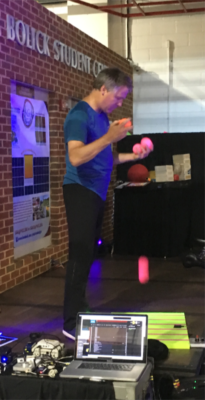 Mark Nizer Juggling brightly colored balls on his stout piano keyboard