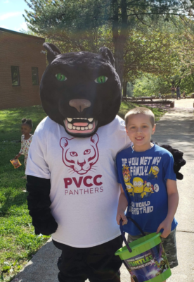 Tristan Miller getting his photo taken with Pouncer the Panther.