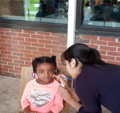 A young girl getting her face painted at the PVCC Easter Egg hunt