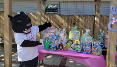 Pouncer showing off the prizes.
