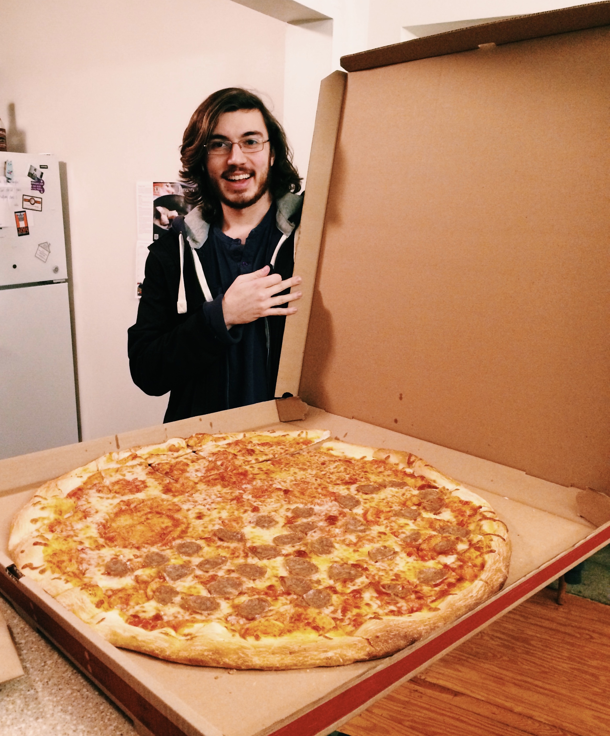 Liam Robb poses with a 28-inch pizza. Photo by MaKayla Grapperhaus
