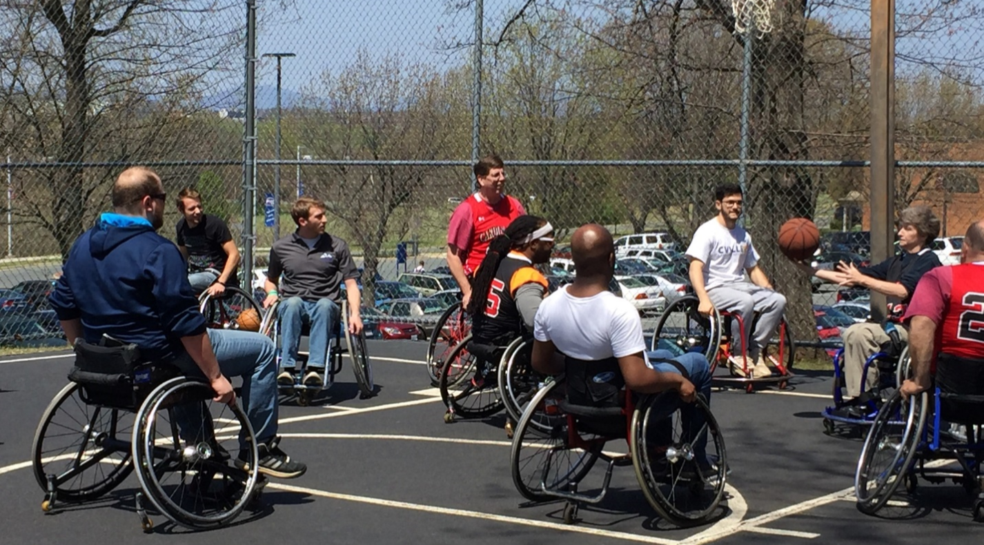 people in wheelchairs play basketball at PVCC