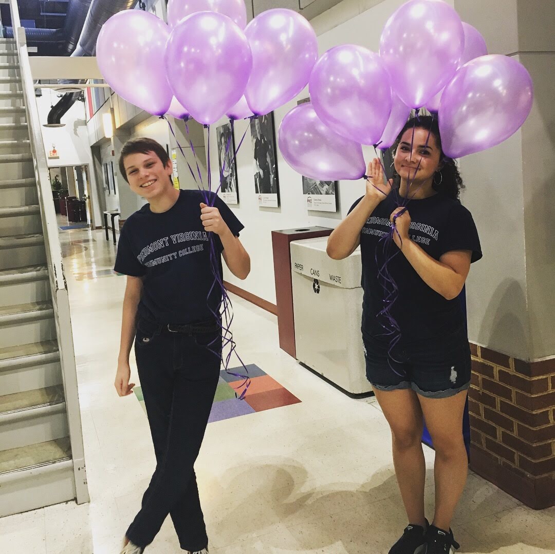 Sophia Keniston and Steve Barker posing with balloons at SOAR. Photography by Madison Weikle.