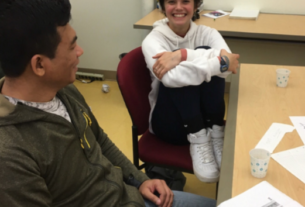 A volunteer and a learner conversing at the Dialogue Cafe