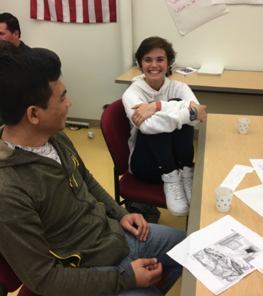 A volunteer and a learner conversing at the Dialogue Cafe