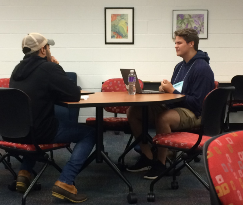 one student checking another student/book out to learn about them