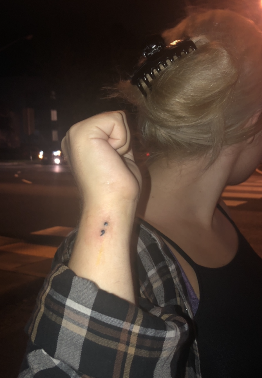 Mitchell displaying her tattoo