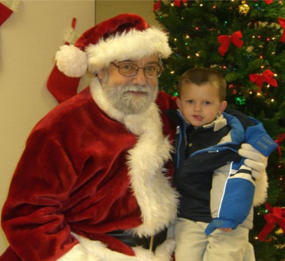 Young local child takes picture with Santa