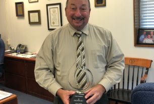 PVCC President showing off his award that he received for his years of service.