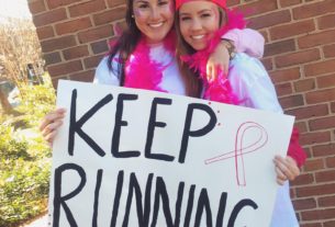 Two ZTA Students cheering on the participants of the 25th Annual Run for Life 5k