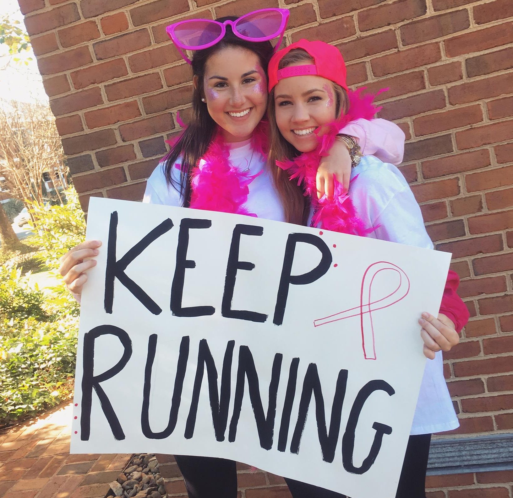 Two ZTA Students cheering on the participants of the 25th Annual Run for Life 5k