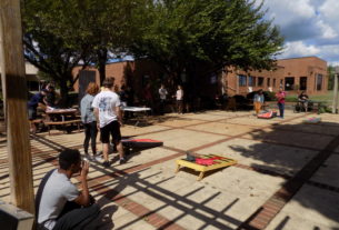 Cru Club members play corn hole.