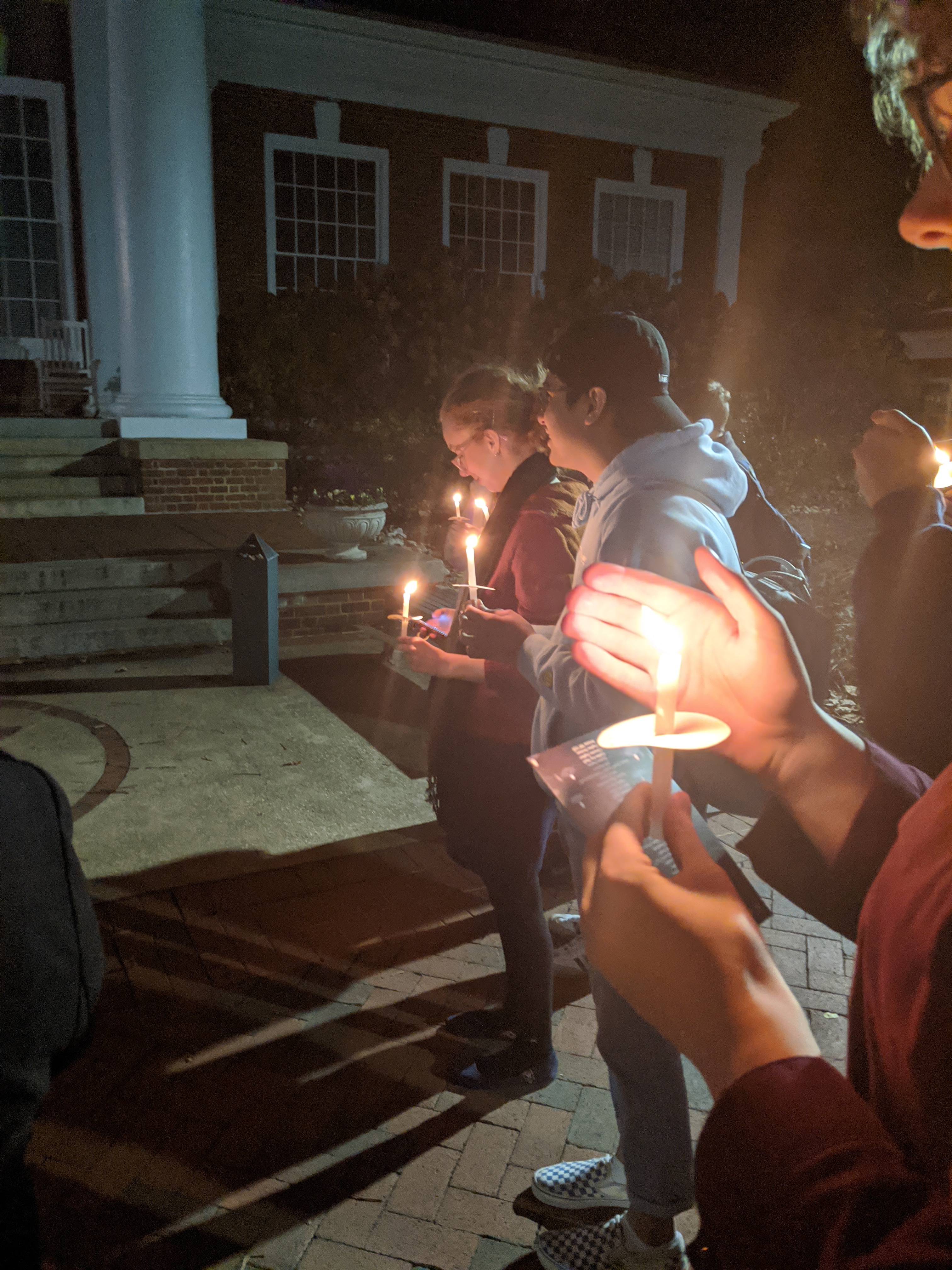 Attendees holding vigil candles