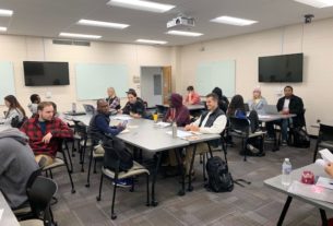 SOC 266 students sitting at table inside the classroom