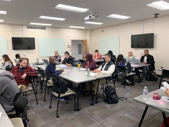 SOC 266 students sitting at table inside the classroom