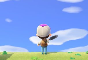 The player character from Animal Crossing stands on a grassy hill with their back facing the camera, shovel in hand. They are looking at the bright blue sky.