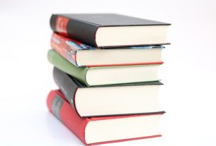 A stack of textbooks with a white background. Picture courtesy of Pixabay.