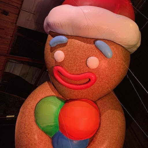 A gingerbread man balloon smiles down at the camera