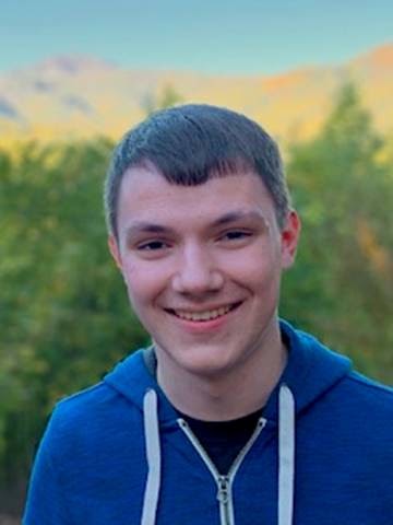 PVCC student Trent Zakielarz poses in front of a serene landscape