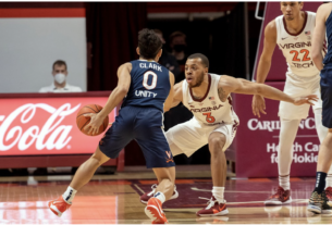 Two basketball players mid-game.