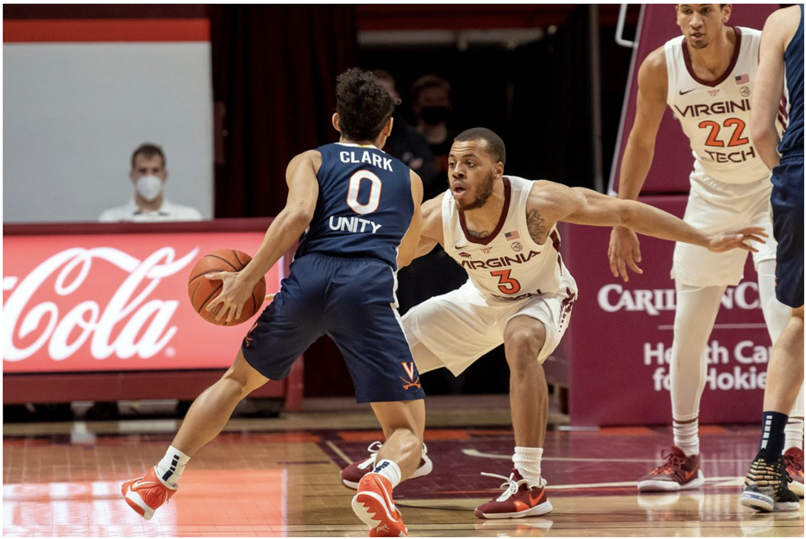 Two basketball players mid-game.