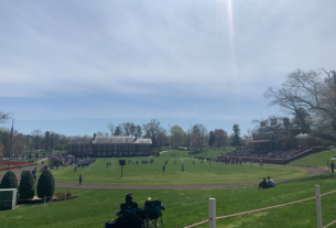 Hampden Sydney vs Ferrum football game on a green with scattered fans in attendance