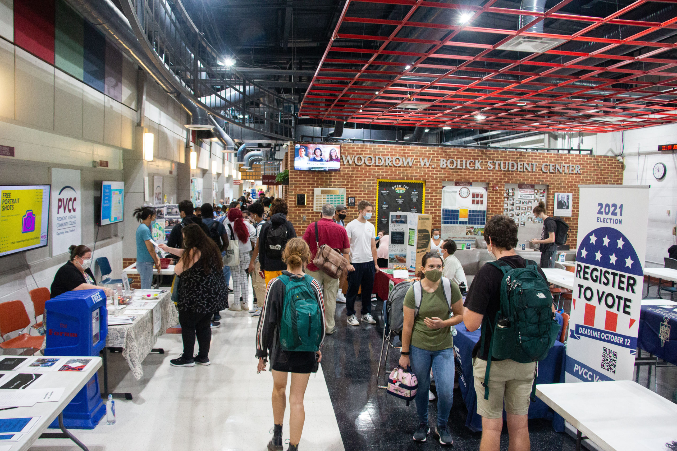 A view of PVCC's main hallway during club day, with numerous students browsing the various club tables