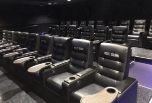 two rows of black empty seats at the violet crown movie theater