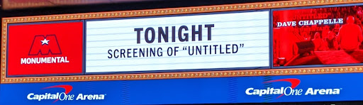 A white sign above a movie theater reading "Tonight screening of 'untitled" in large black letters