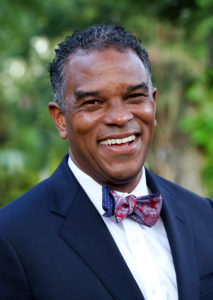 Dr. Walt Tobin smiles at the camera in a suit and bowtie.