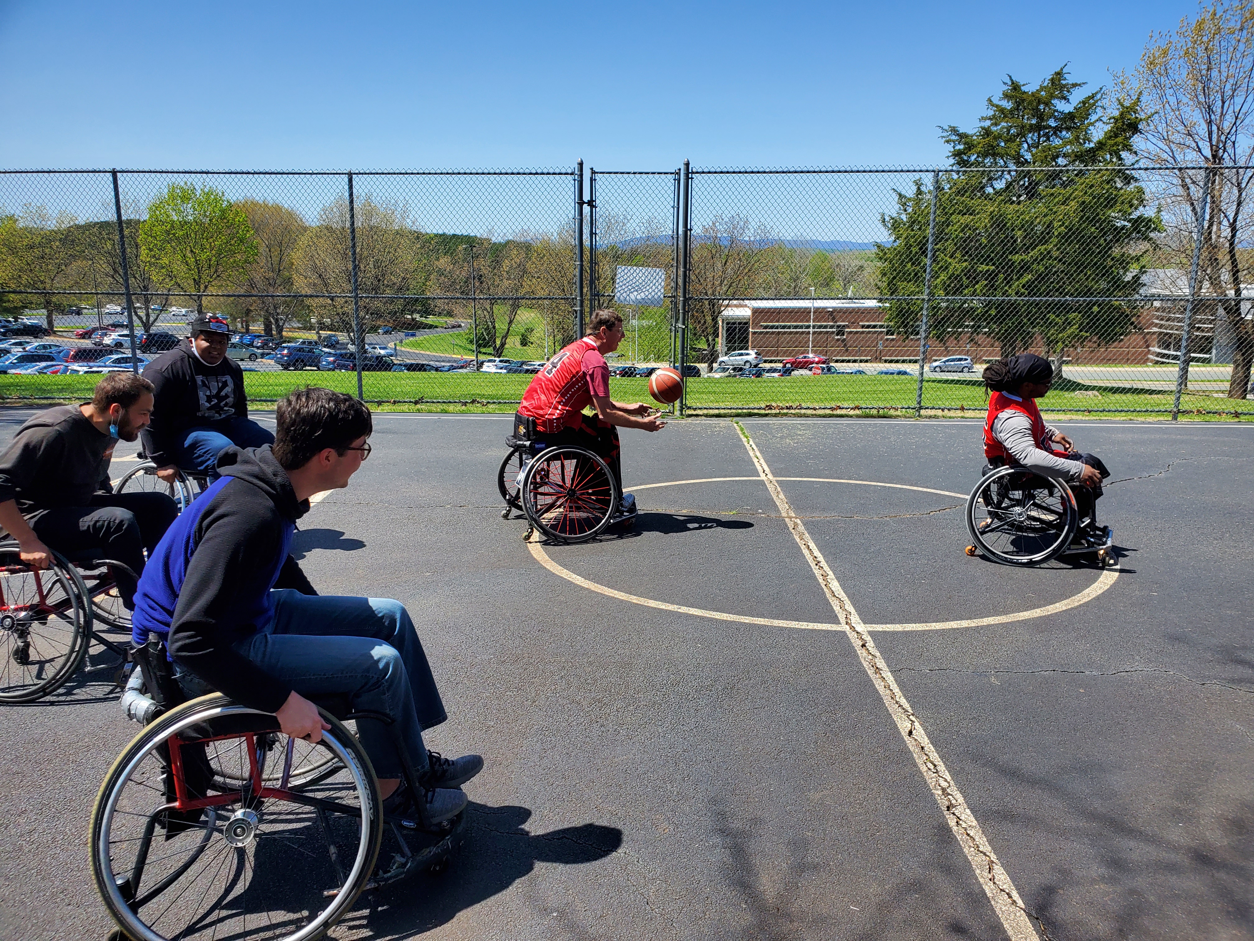 People playing whelchair basketball on the PVCC basketball court.