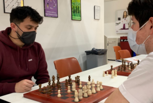 Two people playing chess at club day.