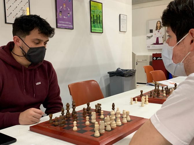 Two people playing chess at club day.