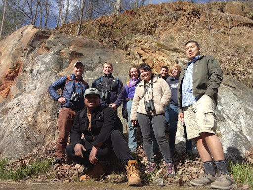 A group of Geology Club members standing infront of a rocky incline.