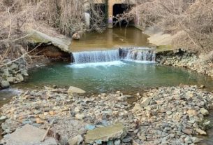 River leading to a split over rocks. A river underpass is visible.