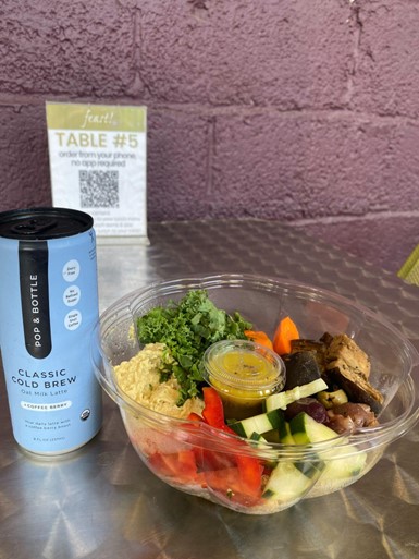 A drink and Mezze Tabbouleh Bowl sitting on a table