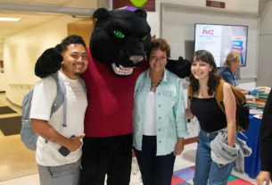 Dr. Jean Runyon poses with the PVCC Panther and students.