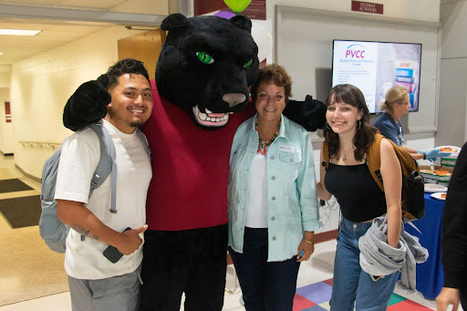 Dr. Jean Runyon poses with the PVCC Panther and students.