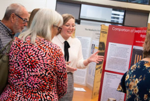 Student Emma Glover presents her research at the poster presentation in the spring of 2022.