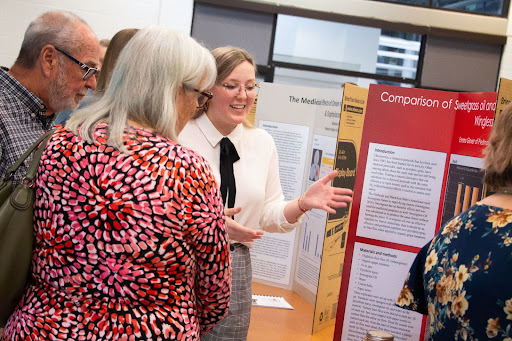 Student Emma Glover presents her research at the poster presentation in the spring of 2022.